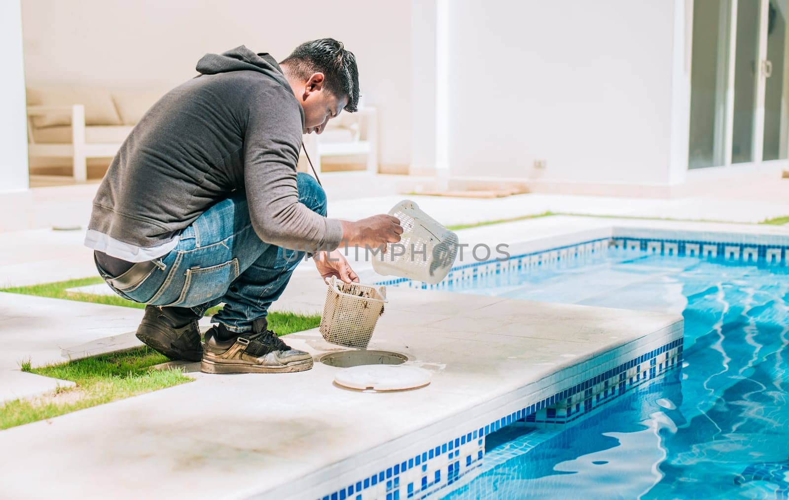 Person cleaning garbage filter basket for swimming pool. Man cleaning swimming pool filter basket