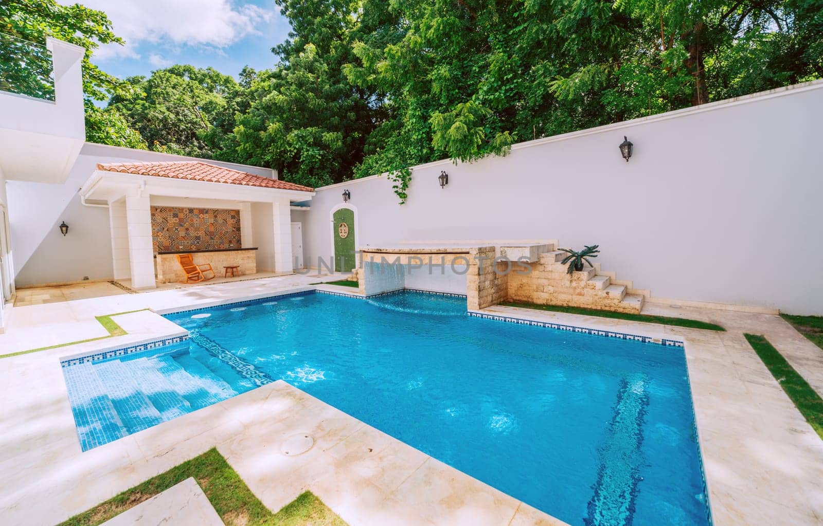 Domestic swimming pool designs. Homemade swimming pool surrounded by nature trees