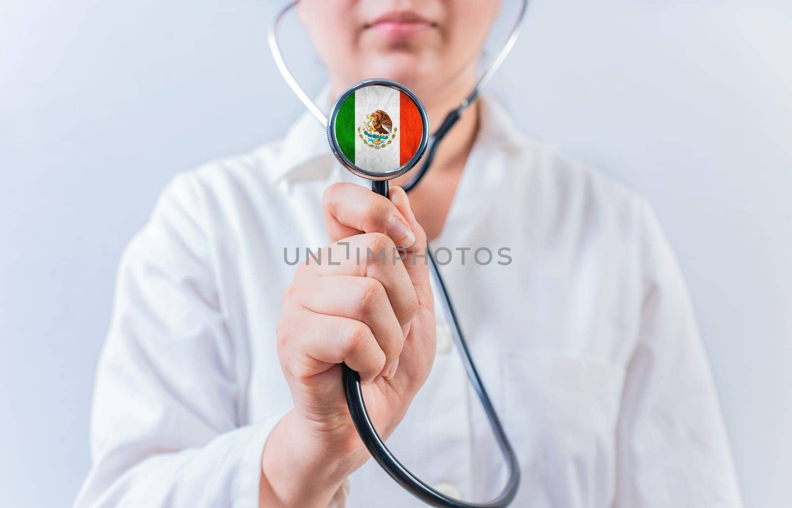 Female doctor holding stethoscope with MEXICO flag. MEXICAN Health and Care concept