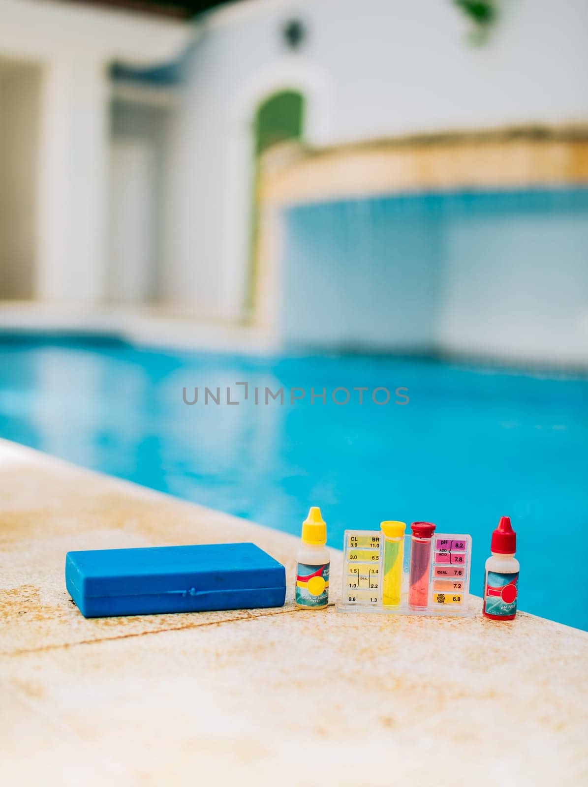 Chlorine and ph tester for swimming pools. Water test kit on the edge of the swimming pool. Chlorine test kit for swimming pools