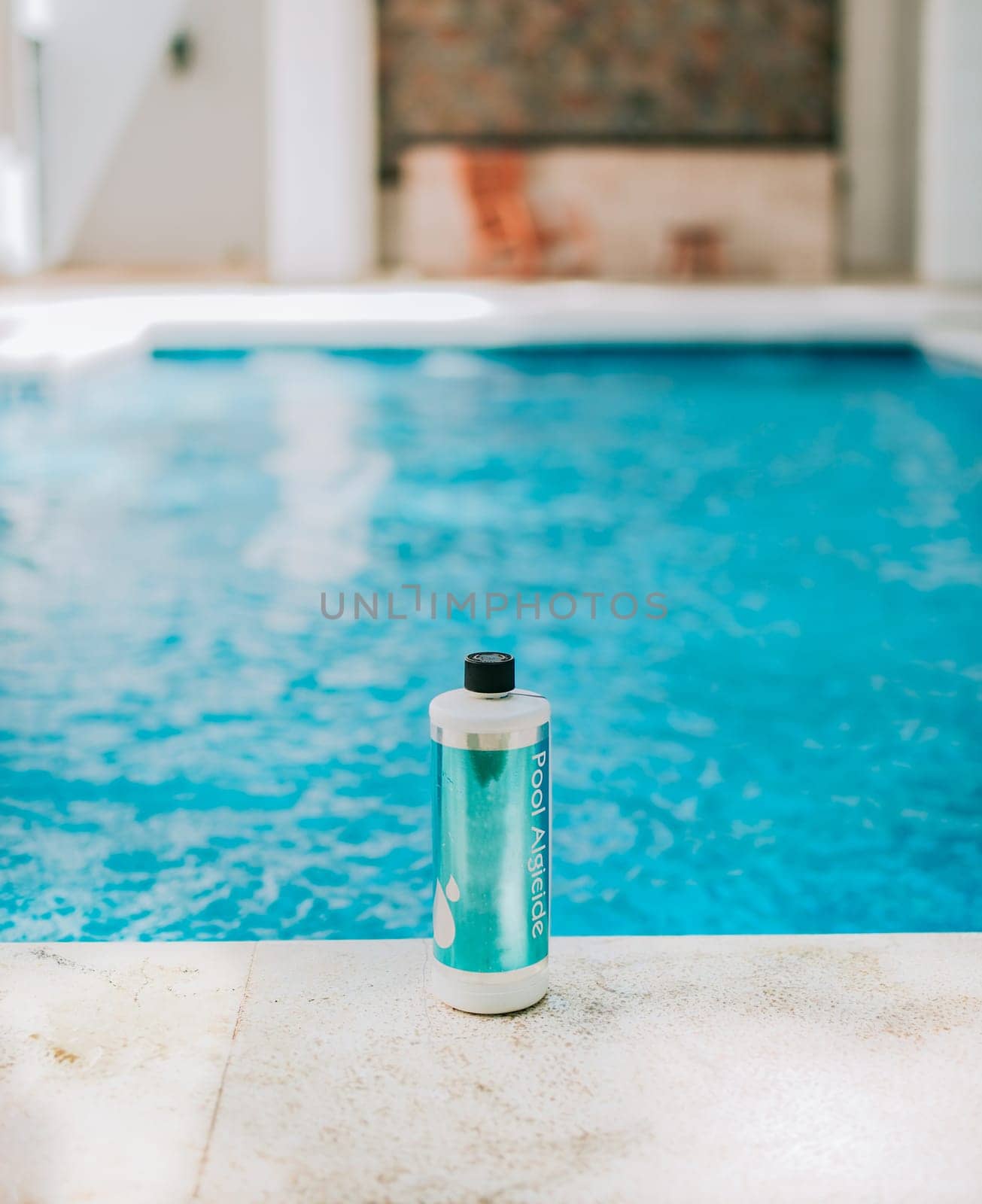 Bottle of algicide for cleaning home pools. Algicide powder for cleaning and purifying swimming pools