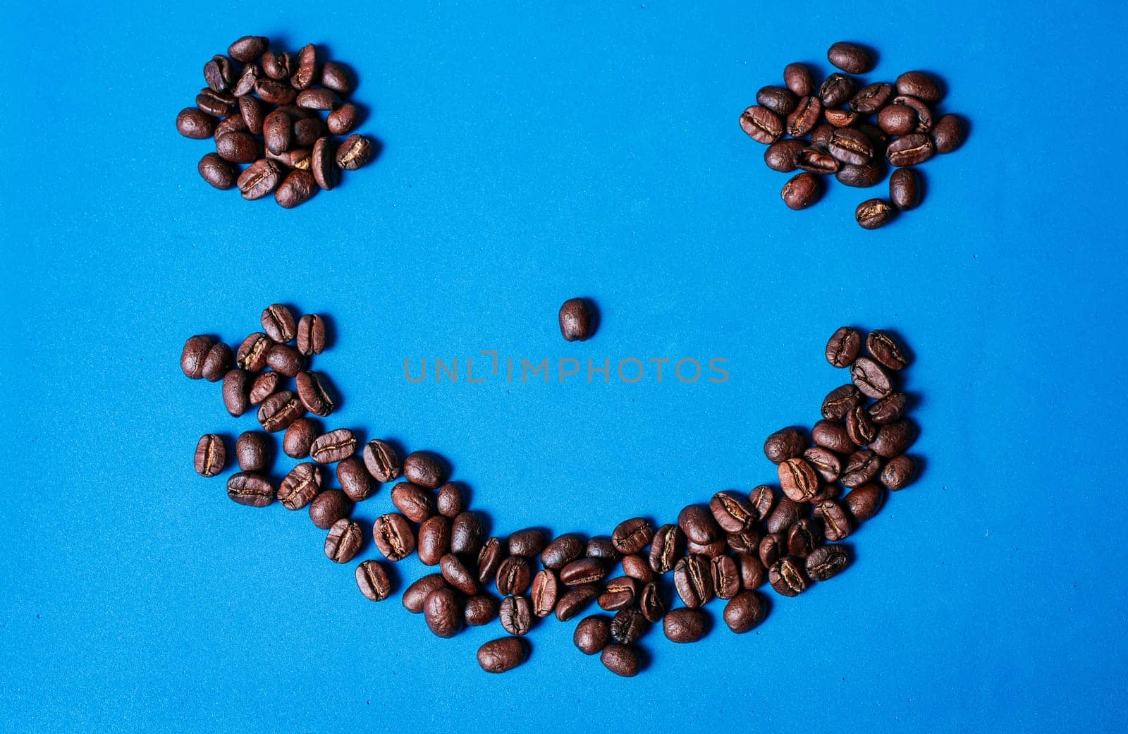 Funny smile from roasted coffee beans. Roasted coffee beans forming a smile isolated