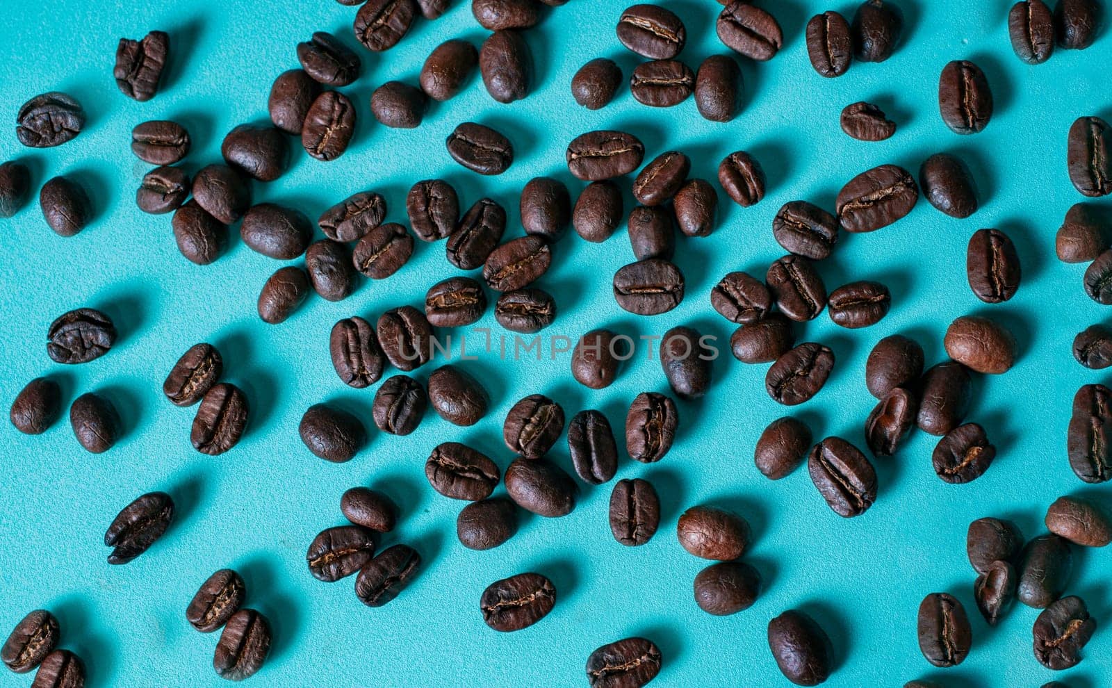 Roasted coffee bulks isolated. Roasted coffee beans on light blue background