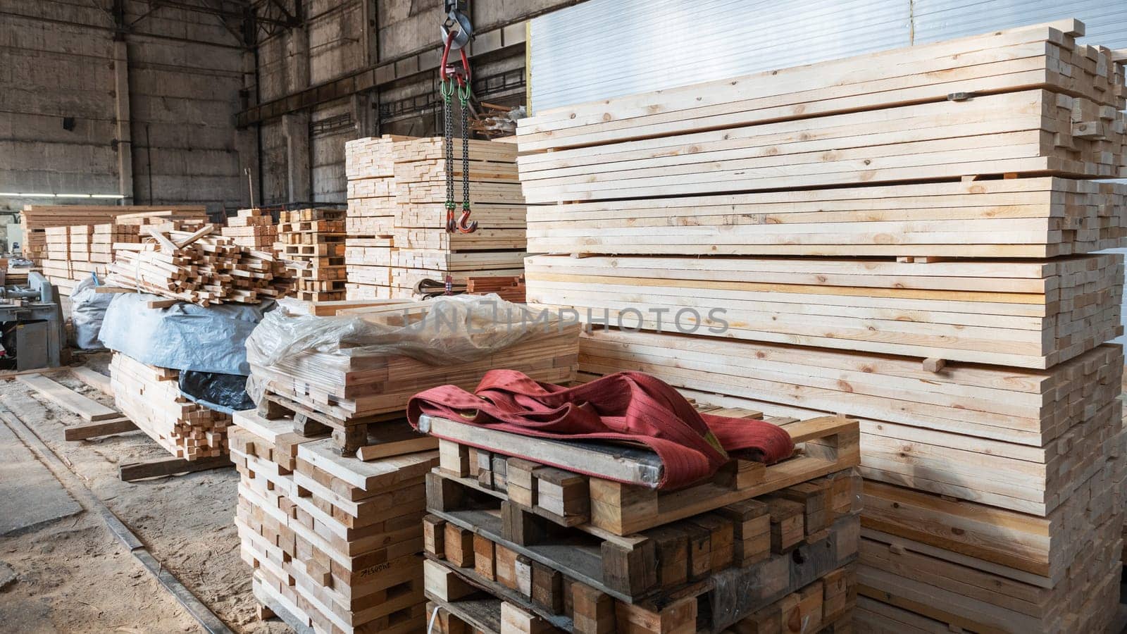 Stacked wooden planks close-up at lumber warehouse. Wood industry concept