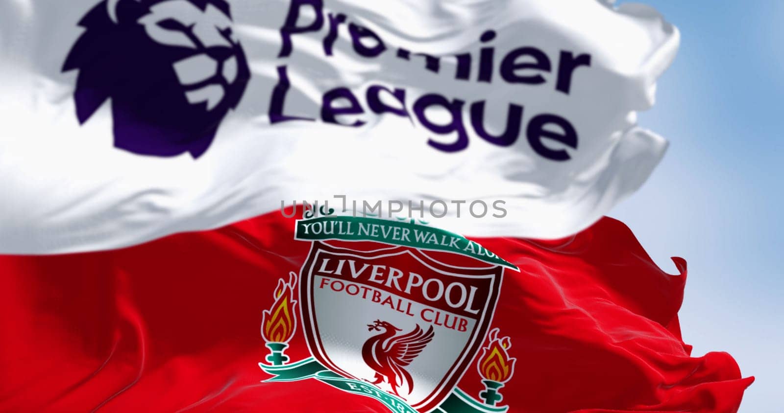 Liverpool, UK  Aug. 14 2024: Close-up of Liverpool Football Club and Premier League flags waving. Illustrative editorial 3d illustration render. Fluttering fabric. Selective focus