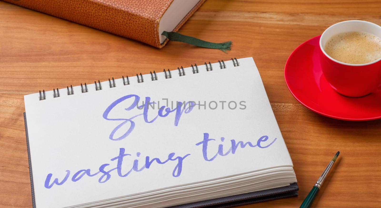 Notepad on a desk - Stop wasting time