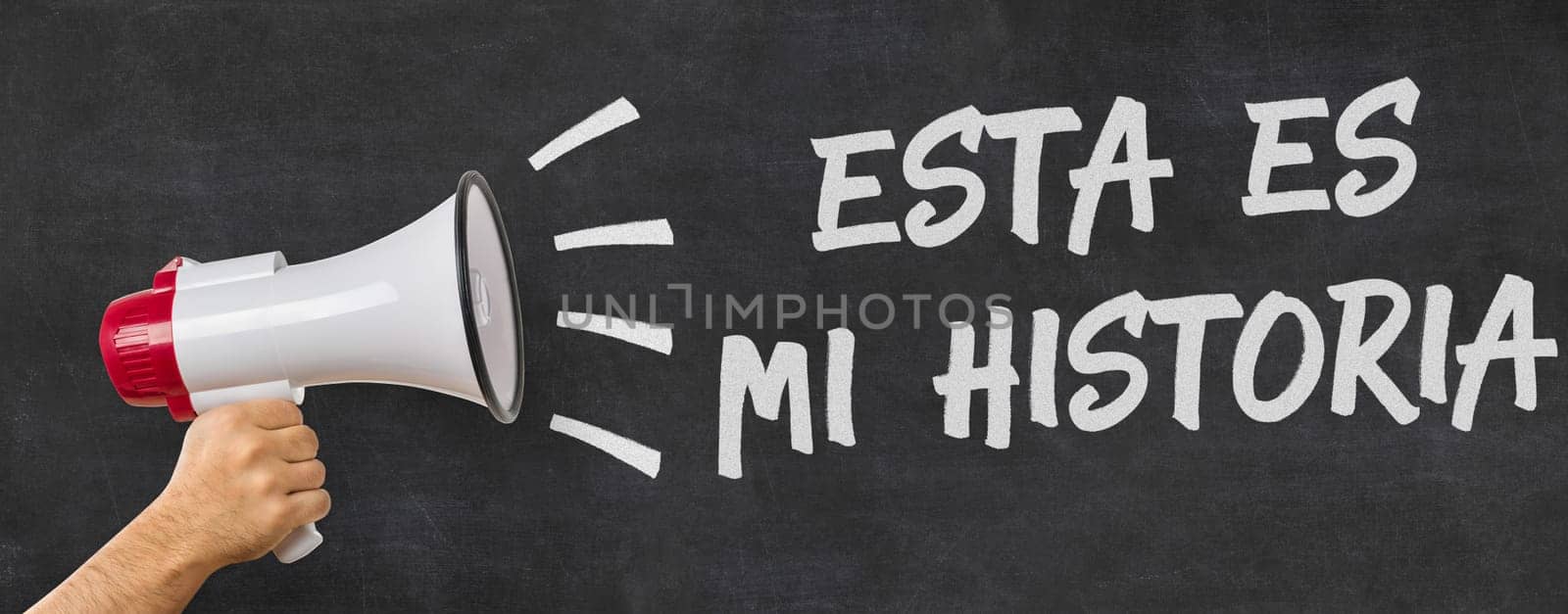 A man holding a megaphone - That is my story in spanish
