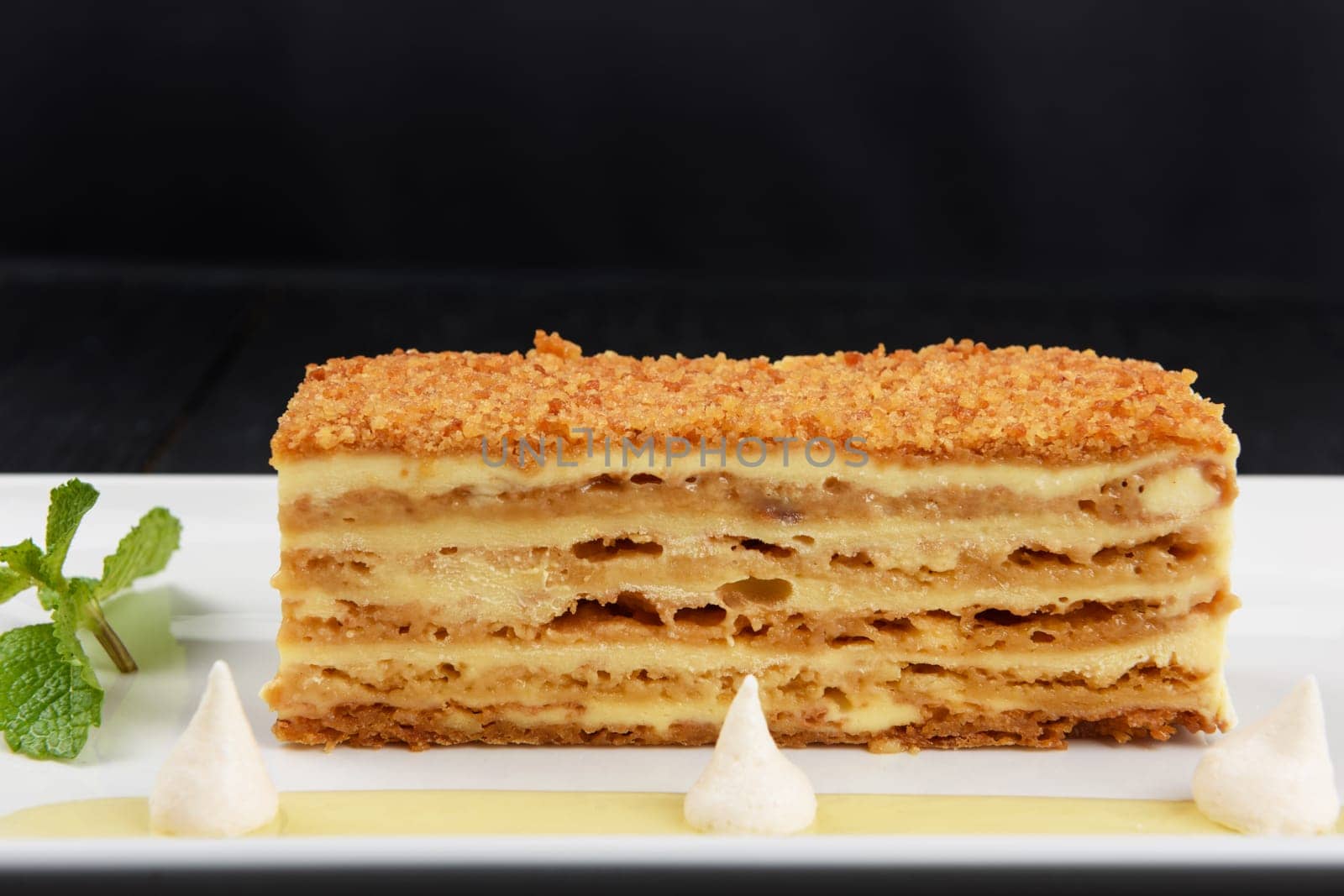 Esterhazy traditional cake on a white plate with mint