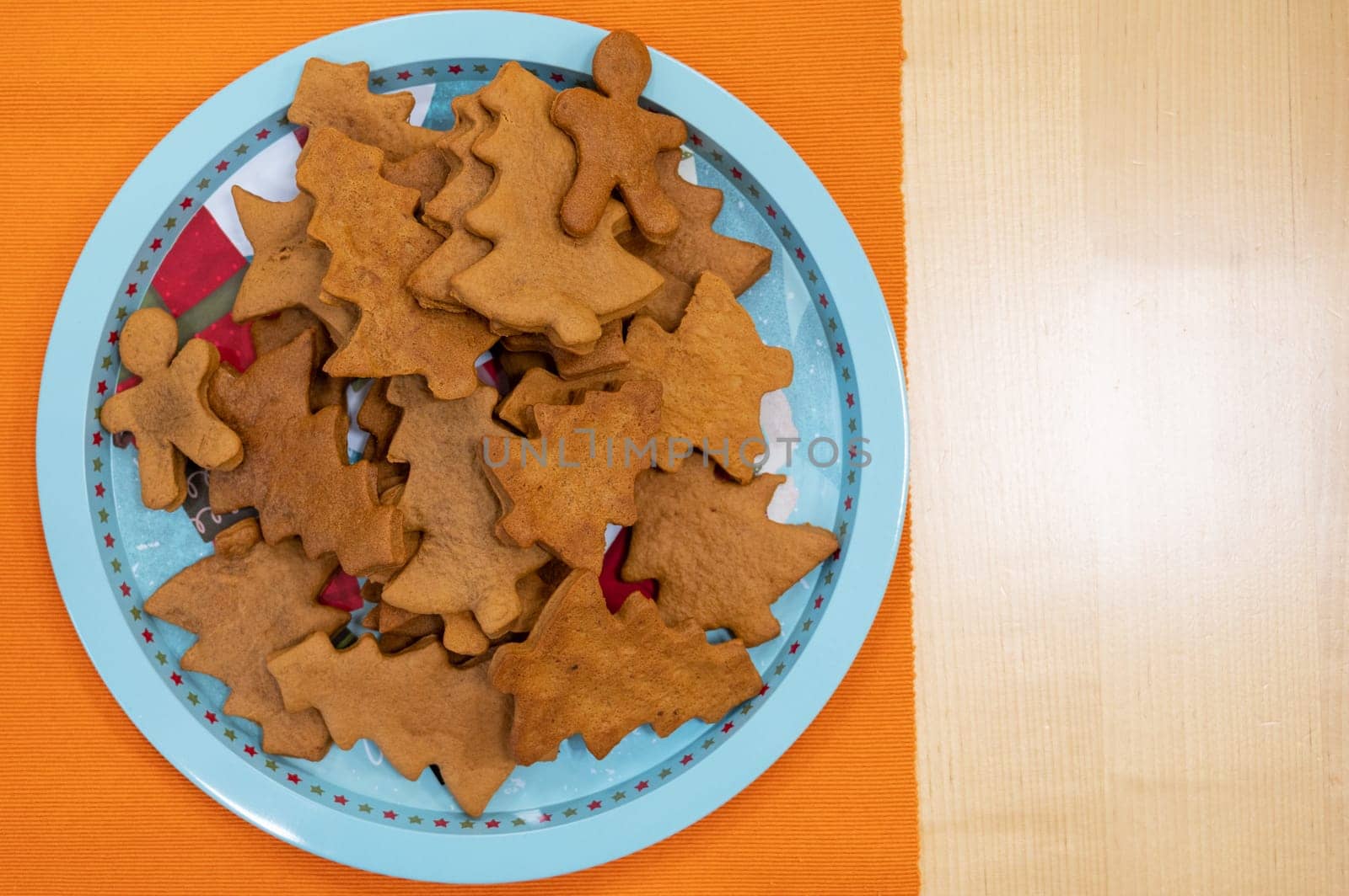 Plate with unglazed Christmas cookies on a table