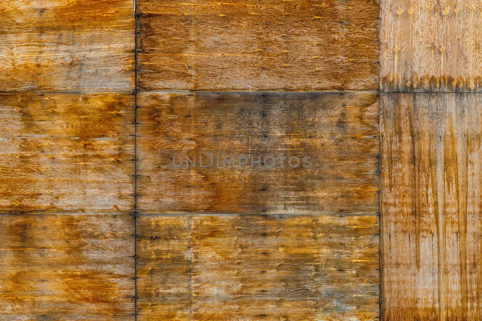stained old brown plywood board wall texture with some water damage