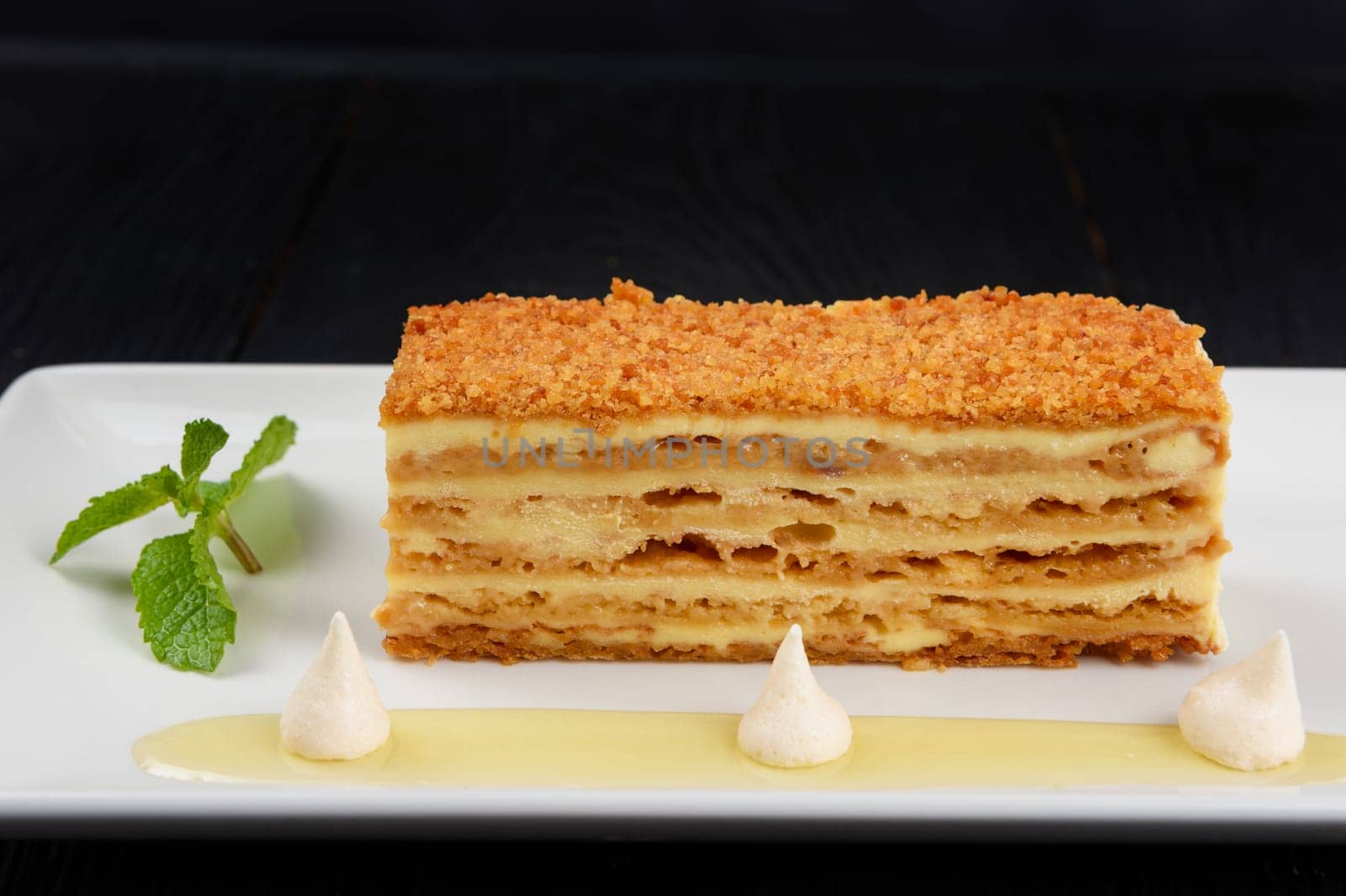Esterhazy traditional cake on a white plate with mint