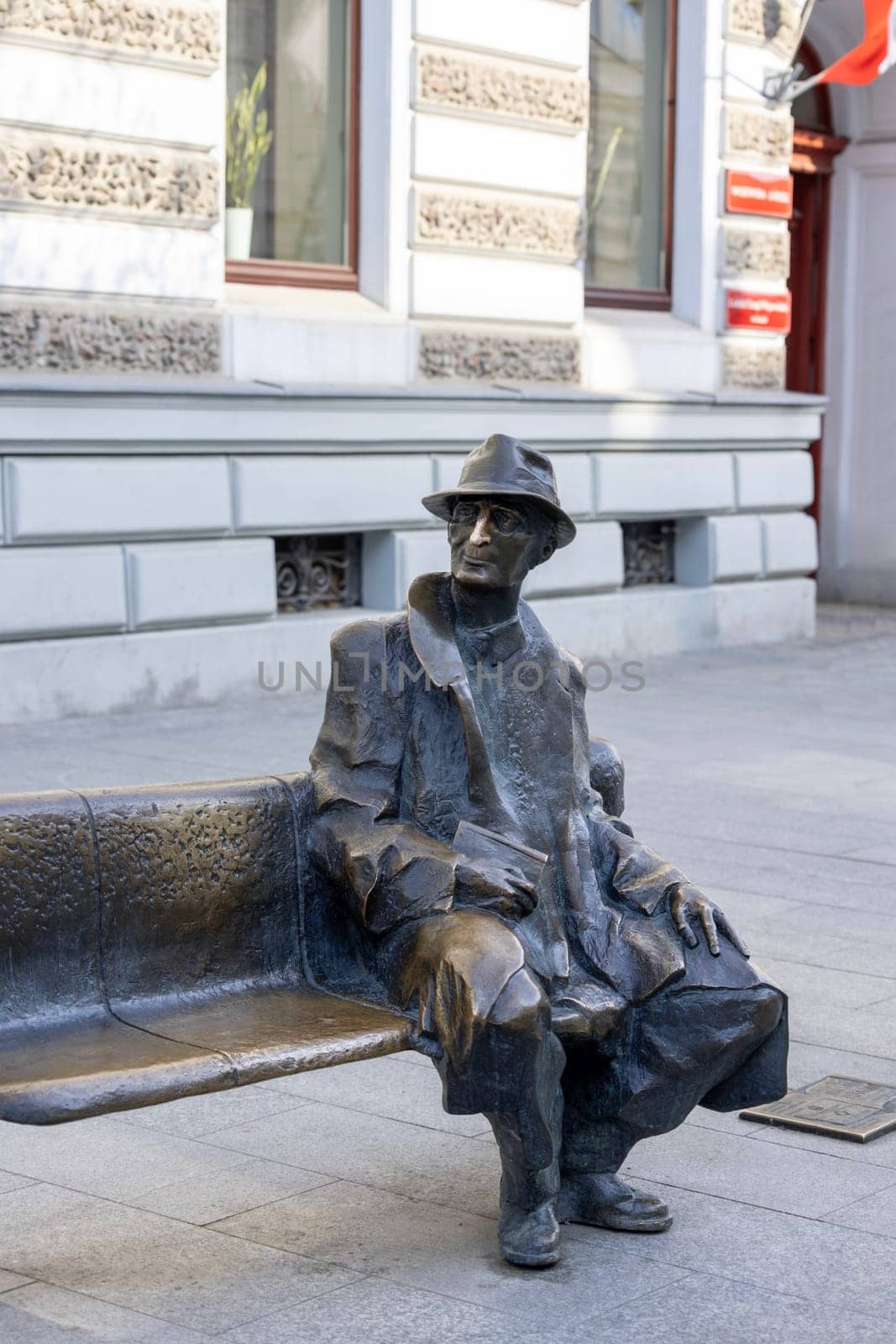 Lodz, Poland - May 4, 2023: Tuwim bench, statue of polish poet of Jewish origin, located on Piotrkowska Street