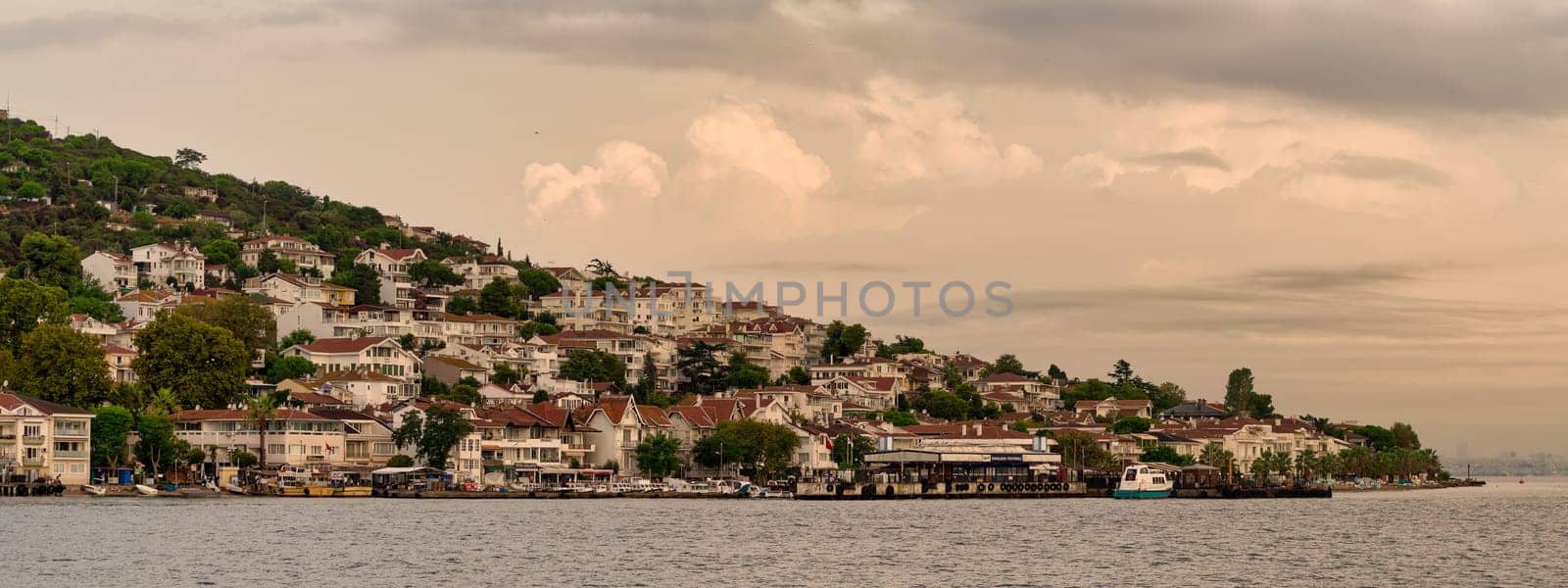 Kinaliada Island showcases hillside homes against a stunning sunset, reflecting the charm of Turkish island life