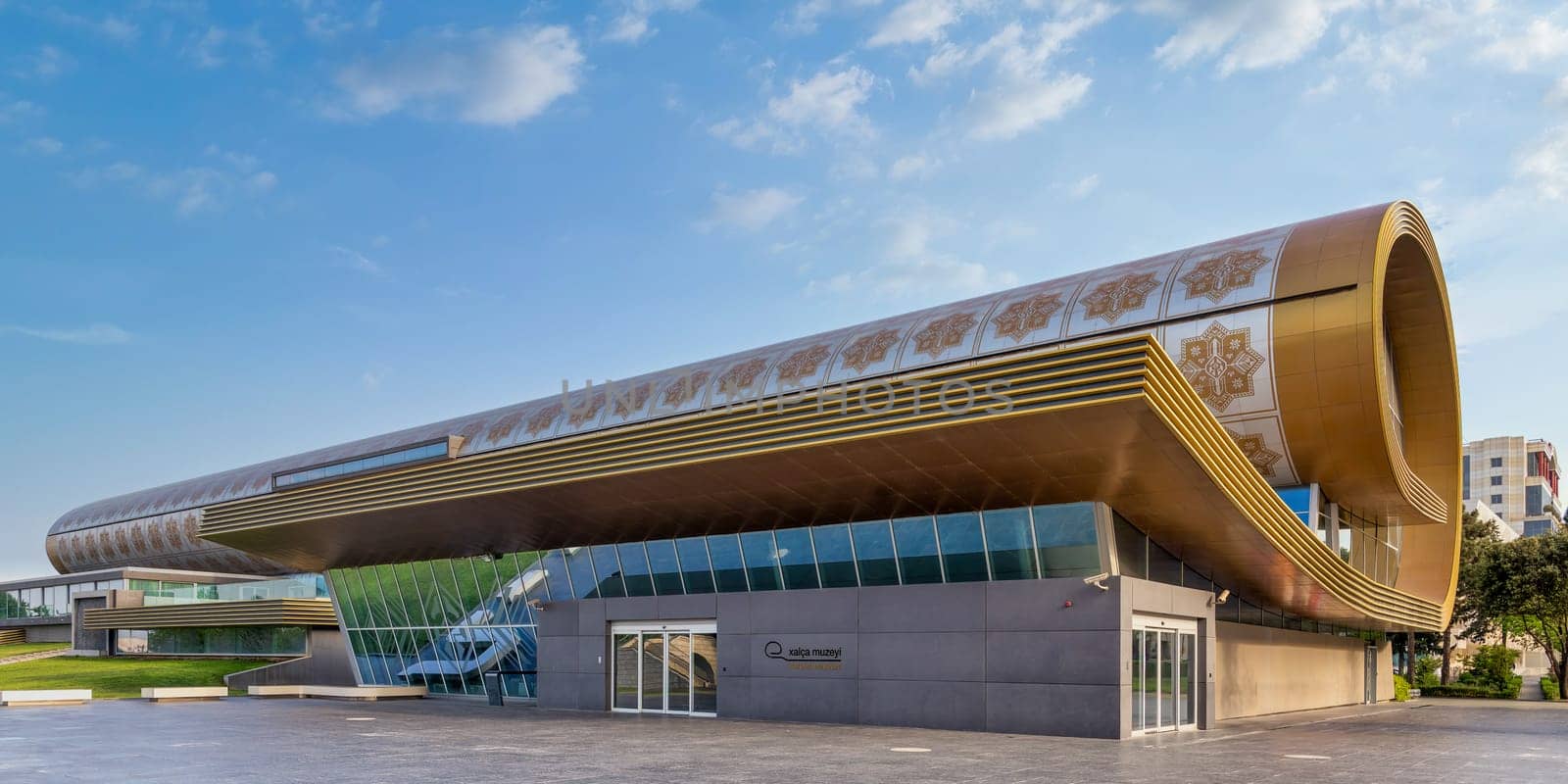 The Azerbaijan National Carpet Museum in Baku showcases innovative architecture, featuring large windows and a unique rolled carpet design