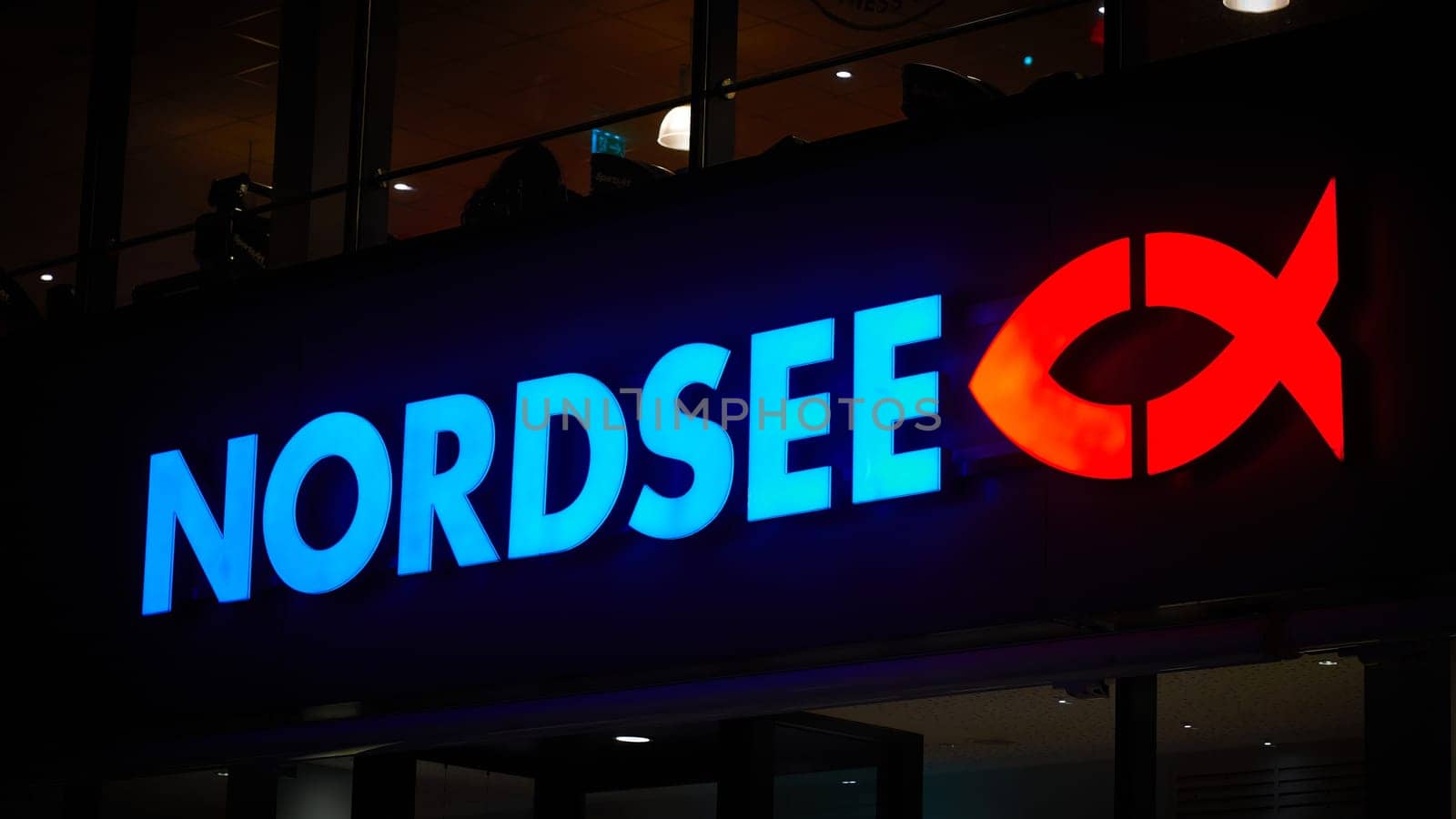 Illuminated sign for the German fast-food chain Nordsee in the evening in Berlin
