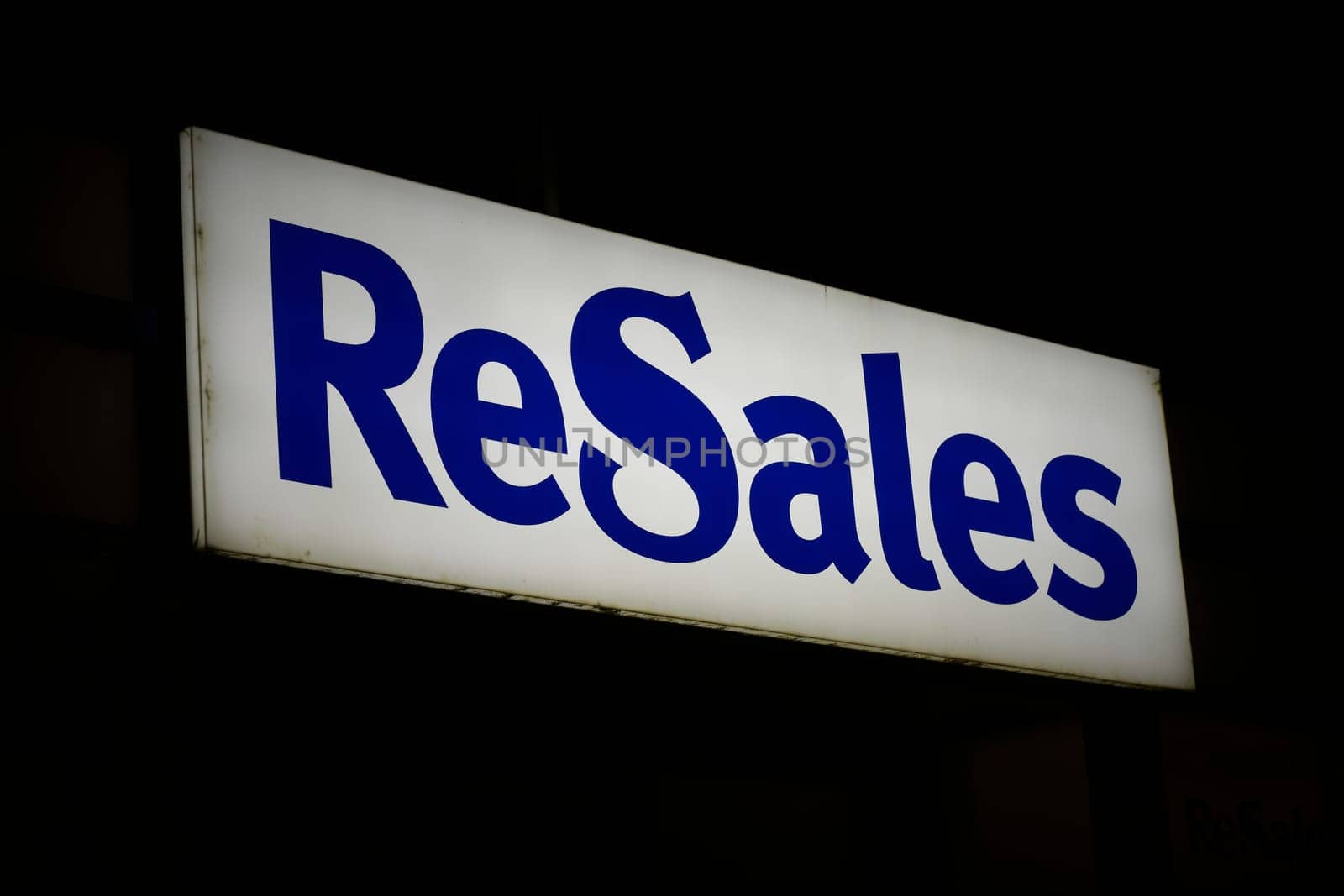 Illuminated advertisement of the largest German provider of second-hand fashion ReSales in the evening in Magdeburg
