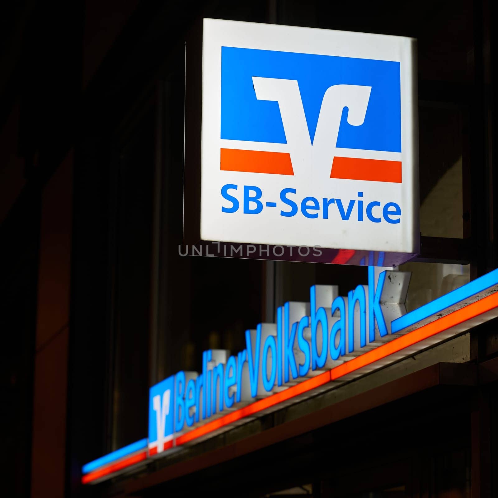 Illuminated sign for Berliner Volksbank, Germany's largest cooperative bank, in the center of Berlin in the evening