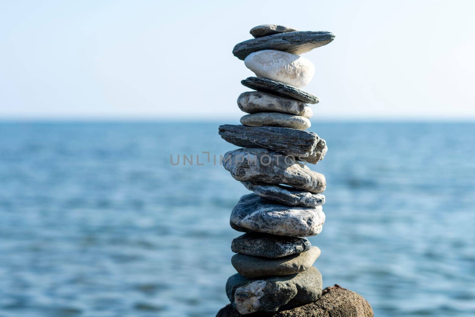 balanced stones on the rocks of the sea