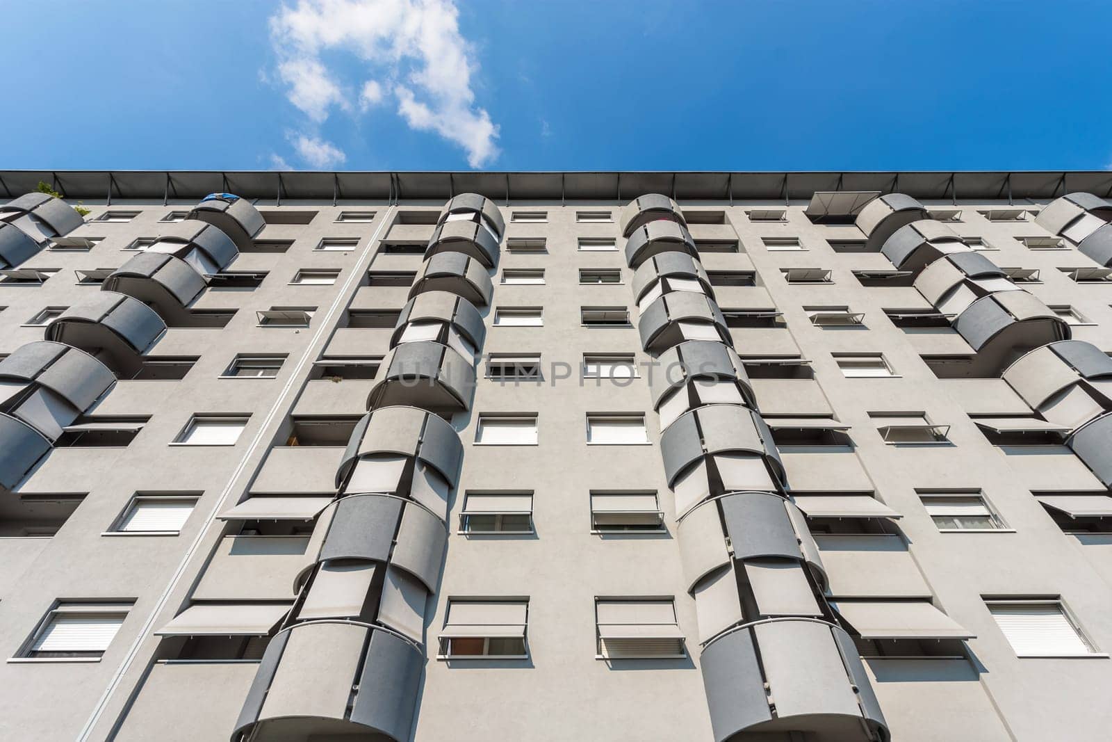 Modern apartment building on a sunny day. Residential building. Facade of a modern apartment building. Bottom view.