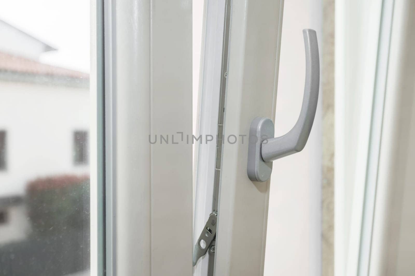 Window tilt open in a city apartment, letting in fresh air. Energy efficiency.