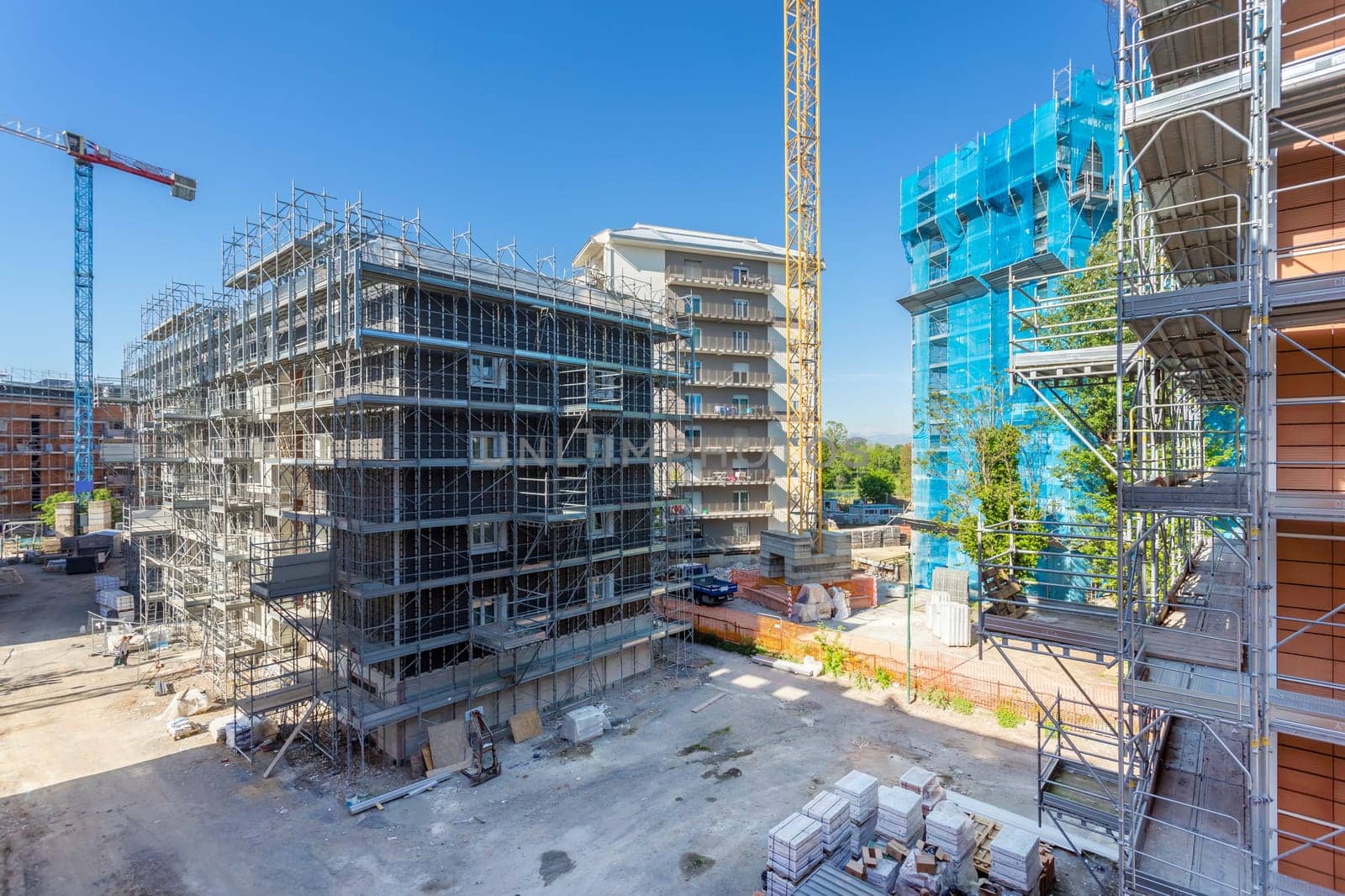 New construction site with cranes. Construction machinery. Construction site of modern apartment buildings.