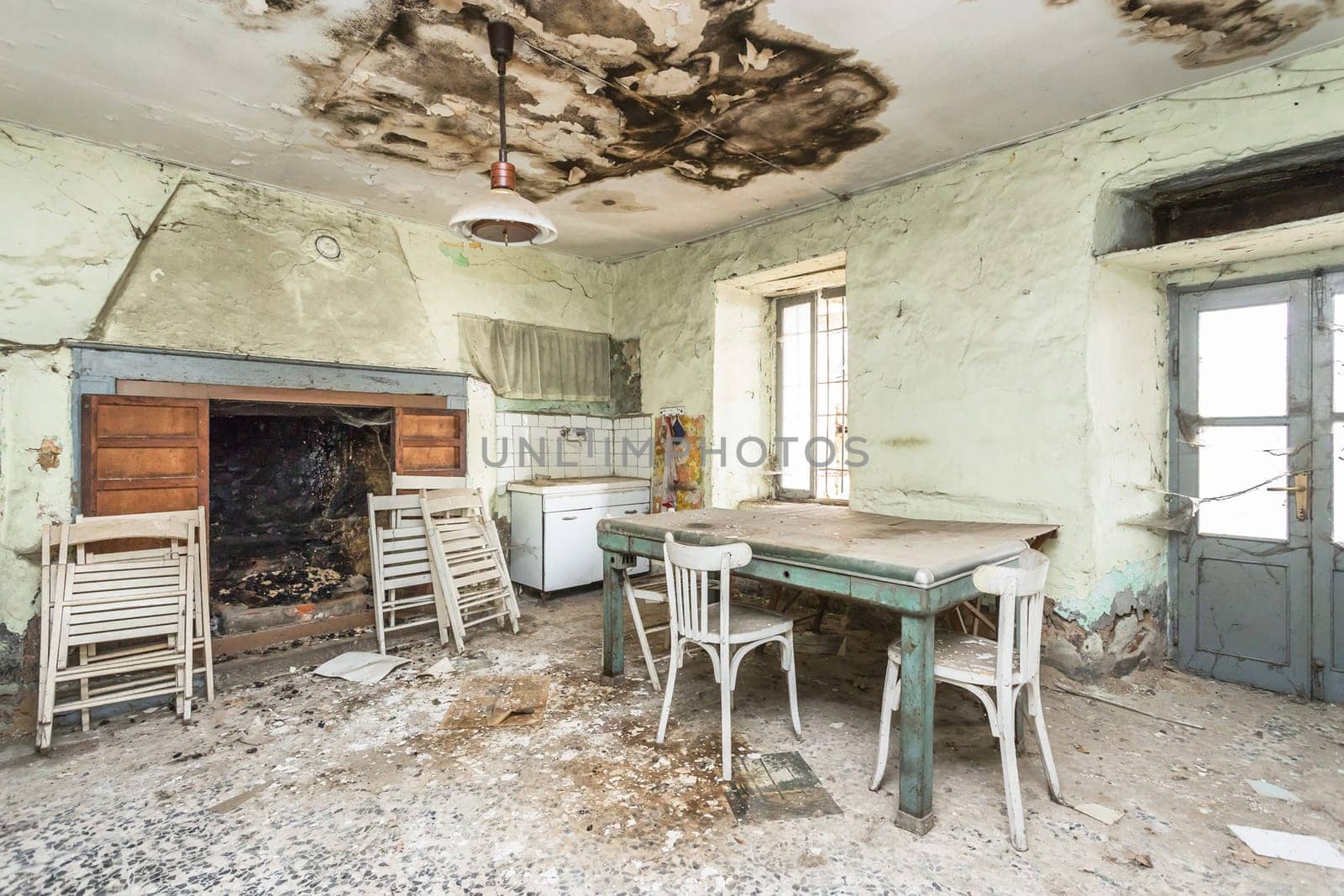 Old house to renovate. Creepy kitchen scenery. Cracked walls and vintage italian floors along with a decay atmosphere.