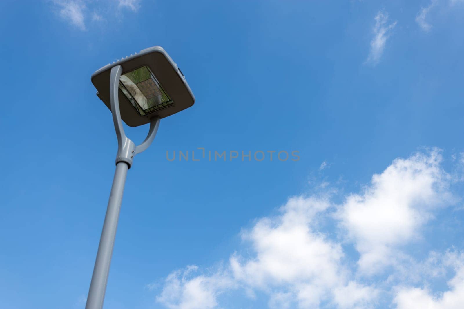 Modern street LED lighting pole. Urban electro-energy technologies. Savings on street urban road lighting.
