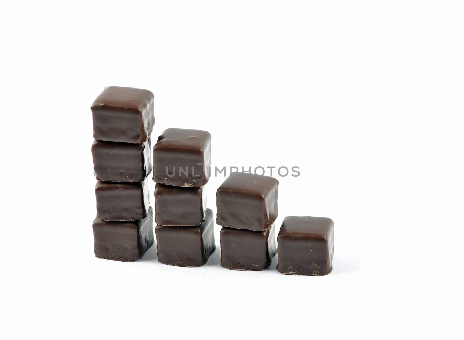 Dominosteine lined up in stacks on white background