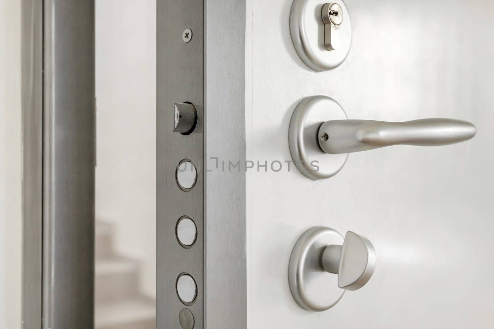 Close-up look at high security lock of an white armored home door