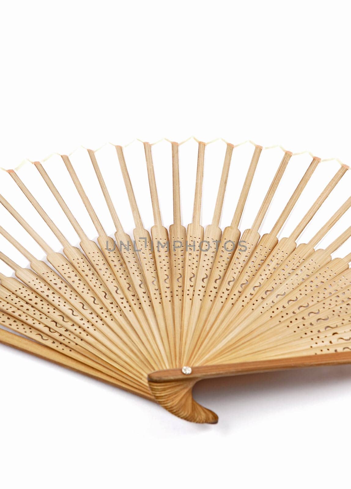Detail of a hand held fan out of bamboo on a white background