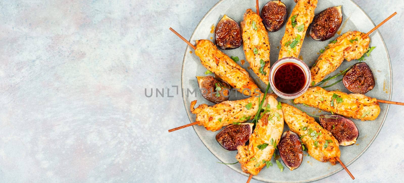 Grill skewers with grilled chicken and figs on a plate. Healthy food concept. Barbecue, chicken kebab. Flat lay.