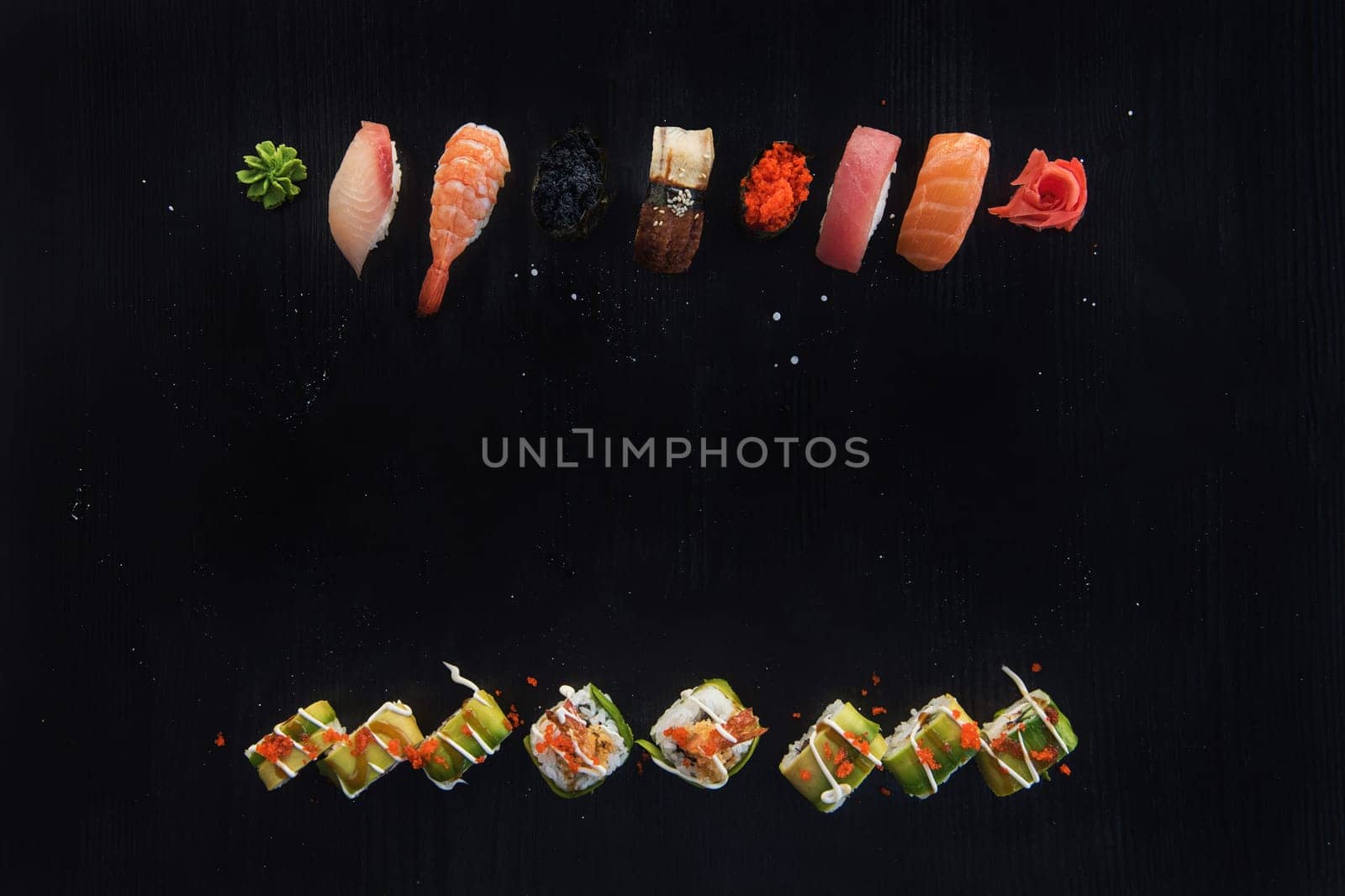 Various kinds of sushi served on wood black table. Concept of sushi menu for Japanese food
