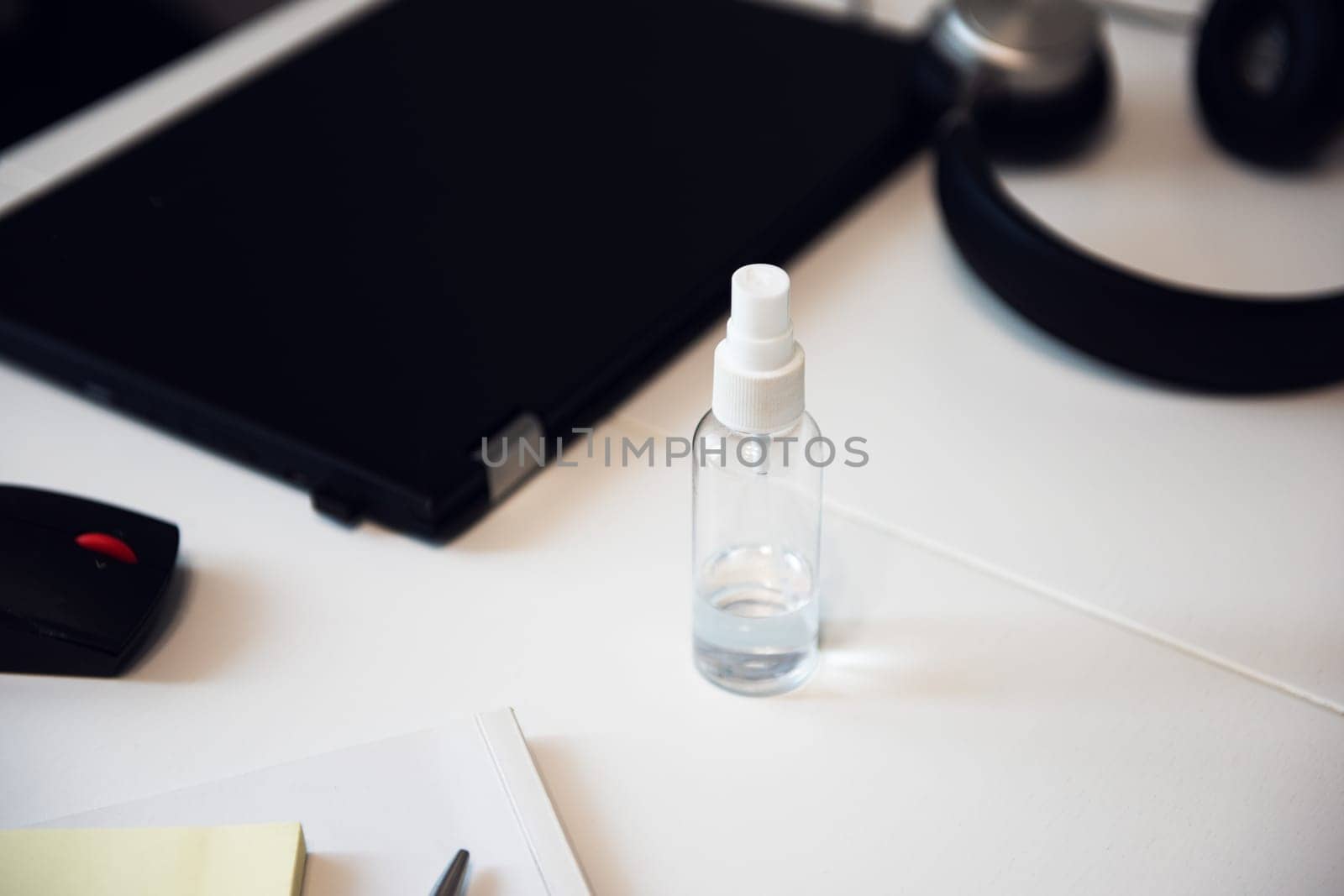 Sanitizer anti virus spray on the working table with laptop. Personal hygiene concept. Concept of quarantine for coronavirus and working from home.