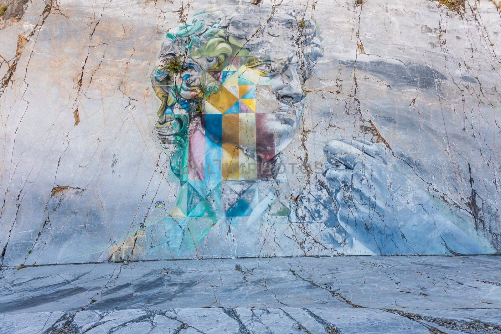 Colonnata di Carrara, Italy - 08 August 2024: the famous David murales by Kobra, inspired by Michelangelo. Street art on white marble, made in 2017.