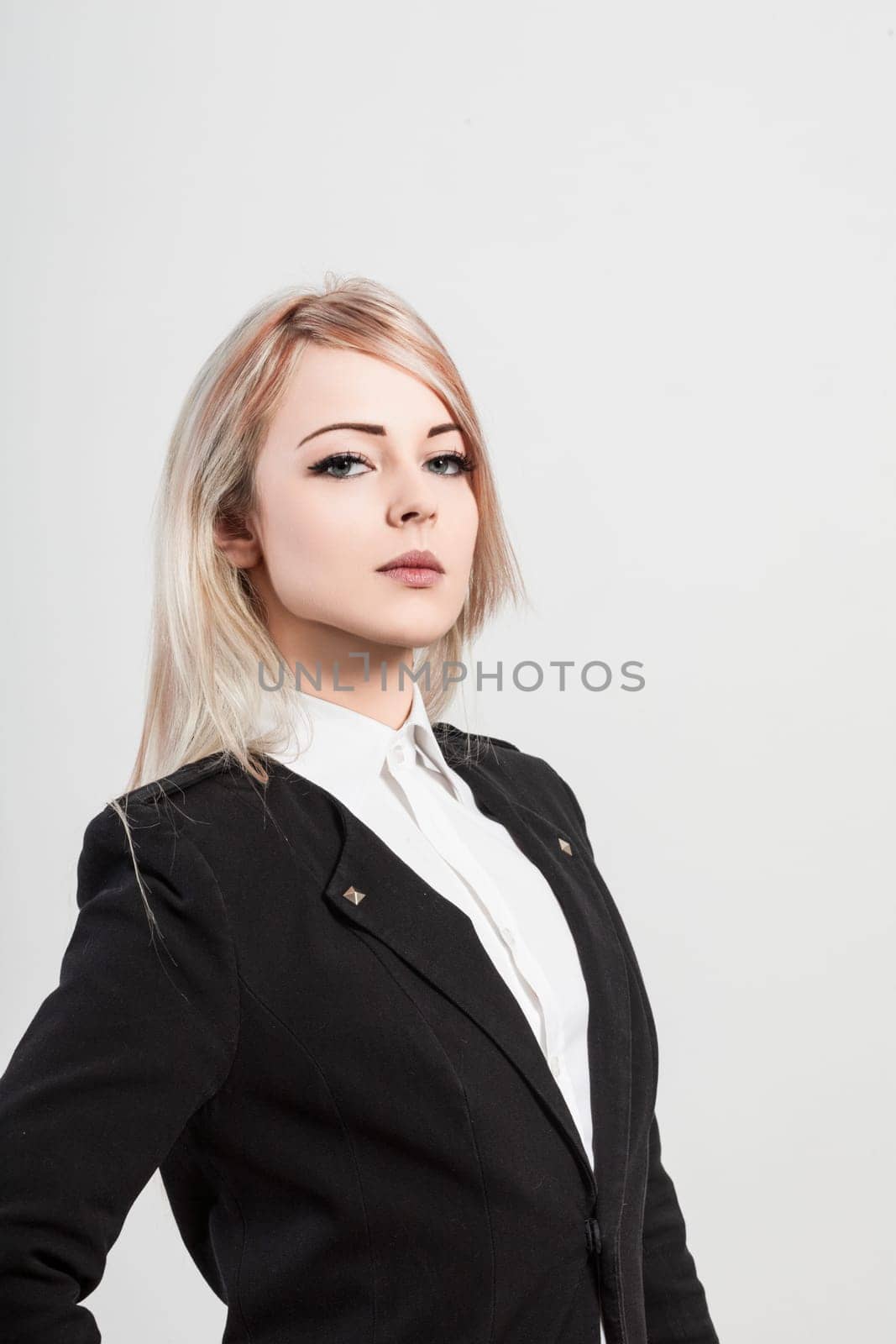 Confident young businesswoman in chic attire exudes determination and ambition, reflecting leadership qualities and modern style. Ideal for business concepts