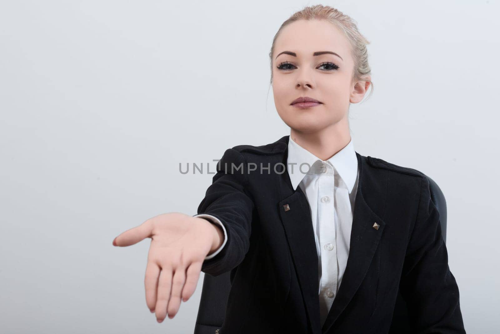 professional female officer in a black uniform extends her hand with a polite smile, requesting the necessary documents. Despite her courteous demeanor, her firm expression shows shes assertive and