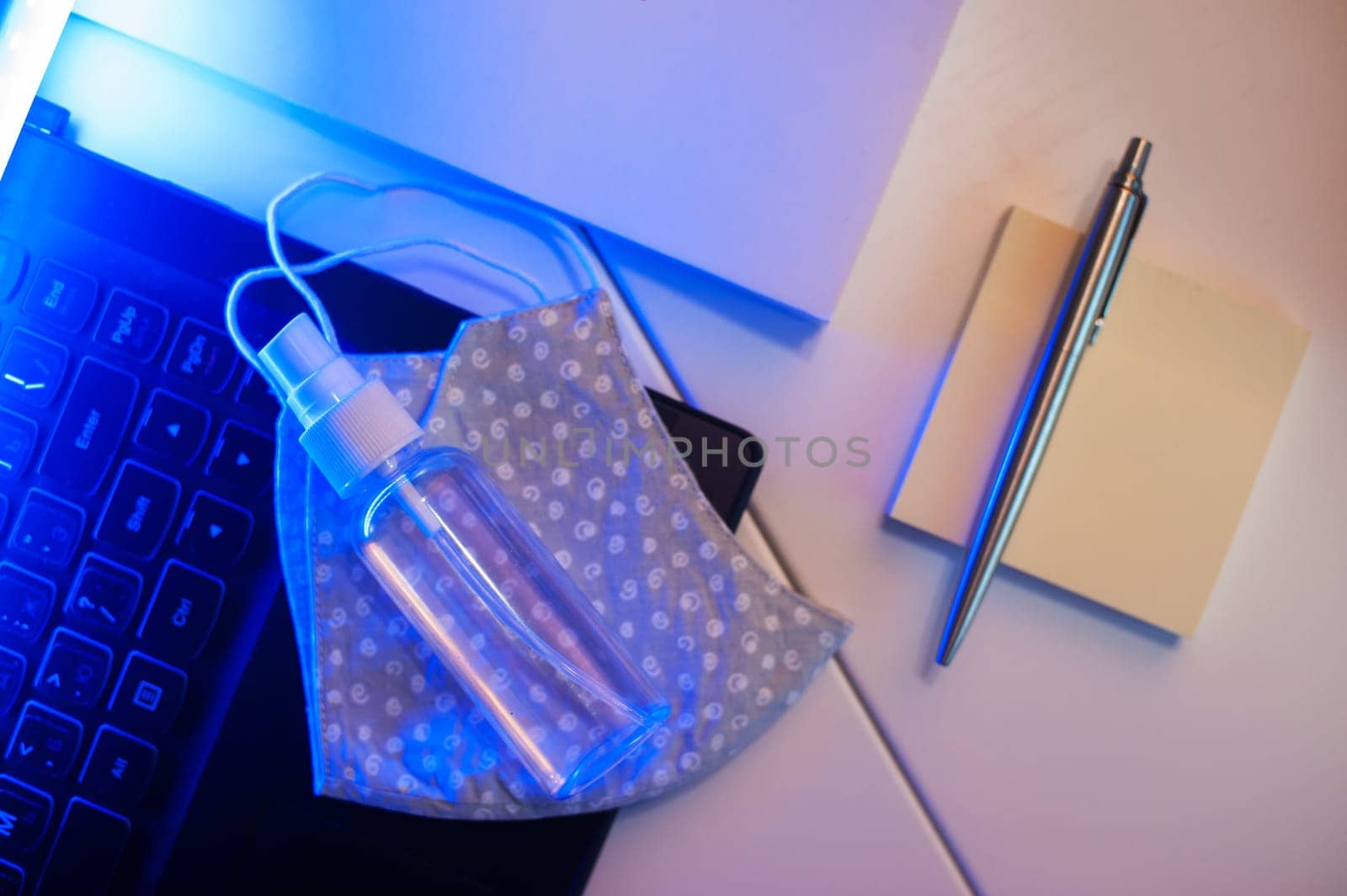 Sanitizer anti virus spray on the working table with laptop. Personal hygiene concept. Concept of quarantine for coronavirus and working from home.