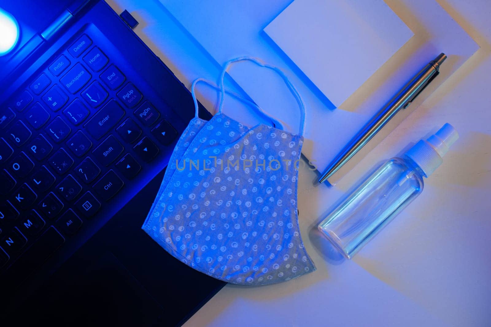 Sanitizer anti virus spray on the working table with laptop. Personal hygiene concept. Concept of quarantine for coronavirus and working from home.