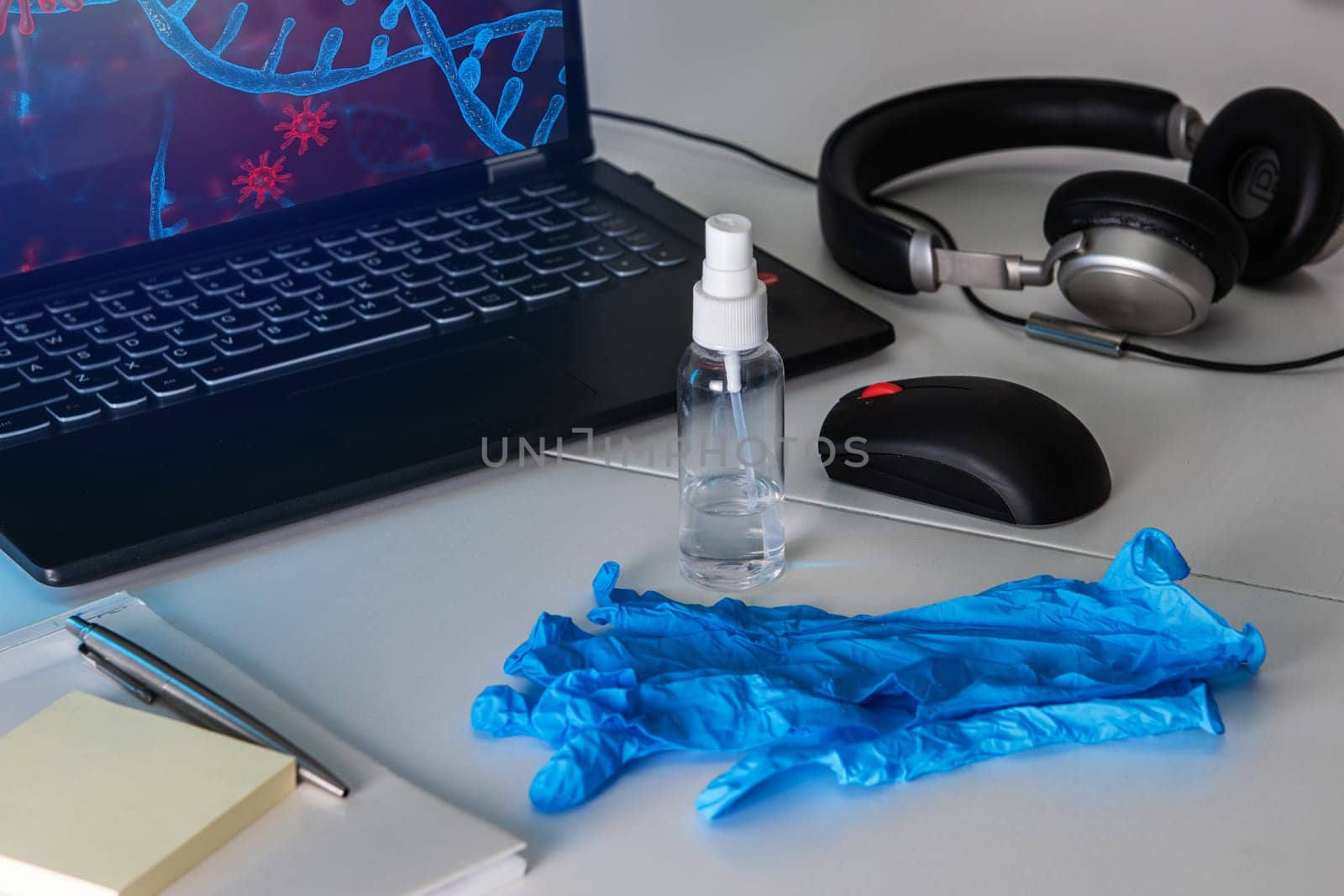 Sanitizer anti virus spray on the working table with laptop. Personal hygiene concept. Concept of quarantine for coronavirus and working from home.