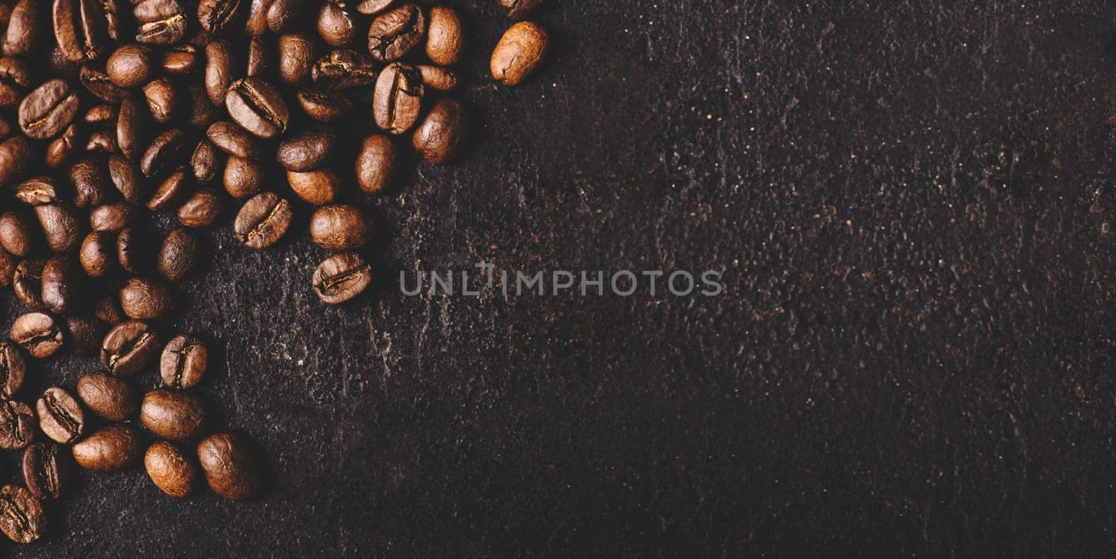 Coffee beans on rustic black background from above. Coffee shop creative menu design layout. Dark vintage banner with arabian coffee top view.