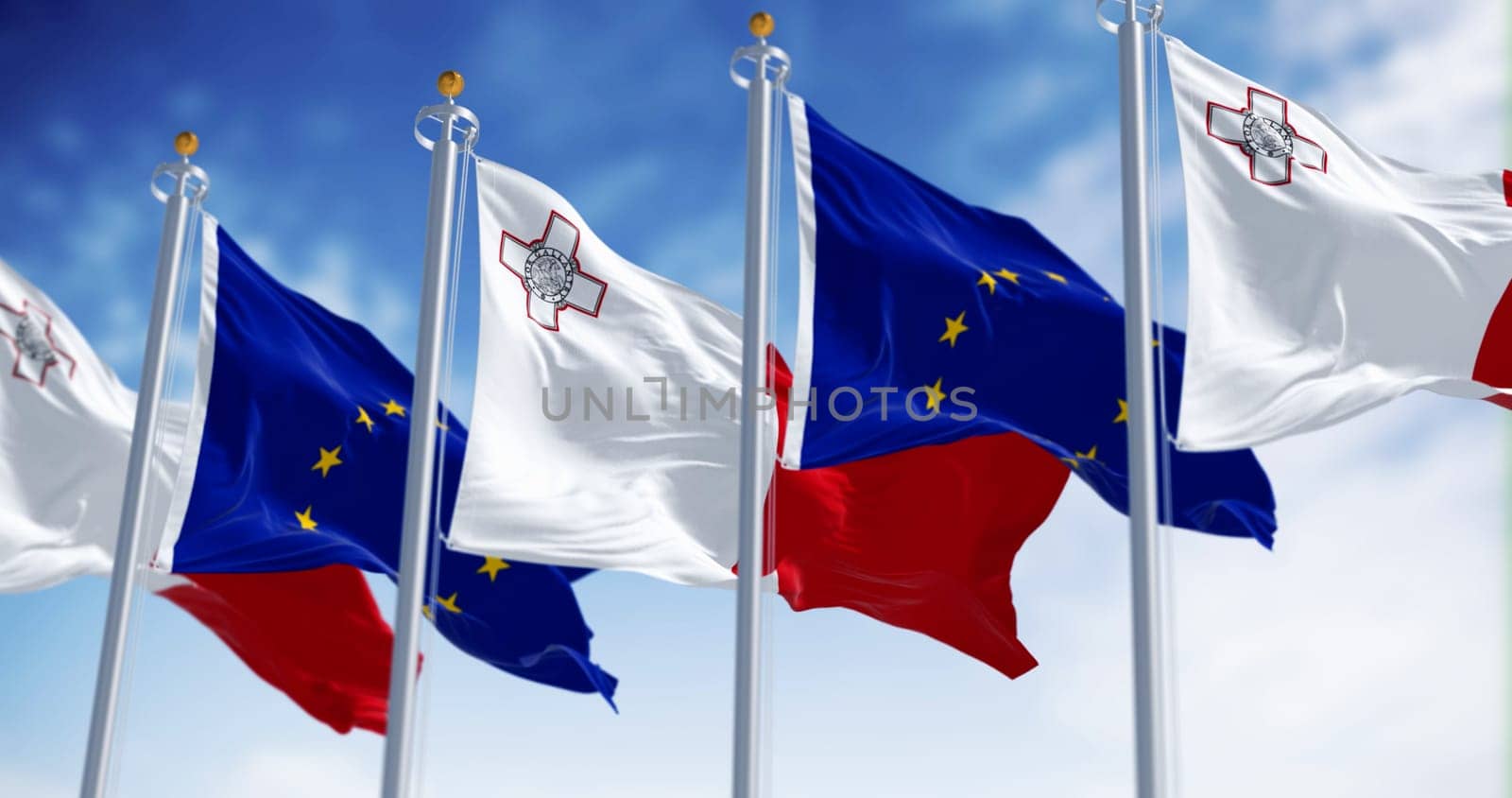 Flags of Malta and the European Union waving in the wind on a clear day. Malta became a member of the EU in may 2004. 3d illustration render. Fluttering textile. Selective focus