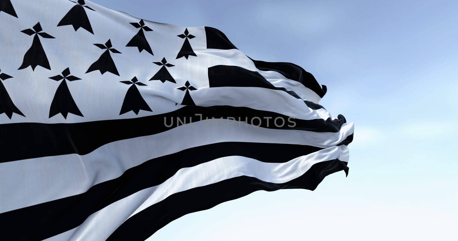 Brittany flag waving with french national flag on a clear day. Brittany is a peninsula, historical country, and cultural area in the west of France. 3d illustration render. Selective focus.