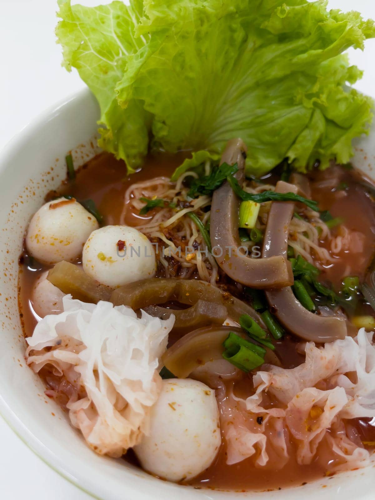 Thai style noodle soup with fishballs and special homemade red sauce, stock photo