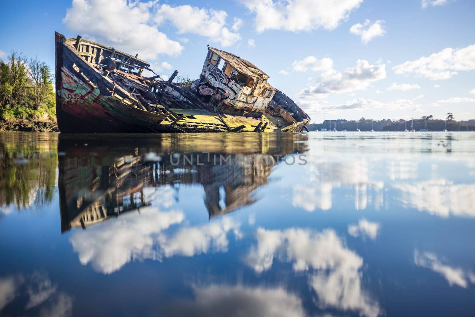 Wooden wreck boat sinking in the clouds