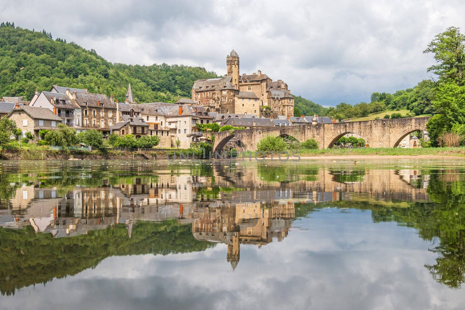 Estaing village, castle and medieval bridge over Lot river photographed in Aveyron, one of the most beautiful villages of France