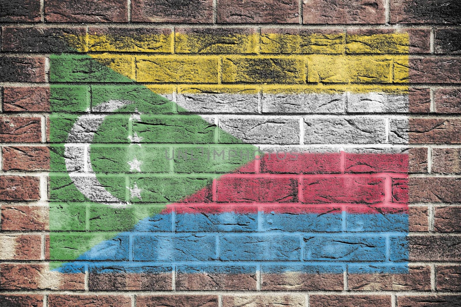 A Comoros flag on an old brick wall background