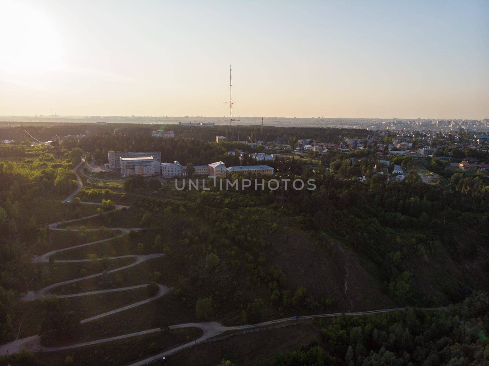 Aerial top vew of winding road in the city, drone shot