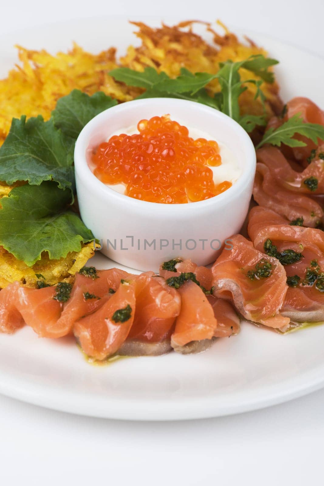 Plate with potato pancakes salmon fish and red caviar