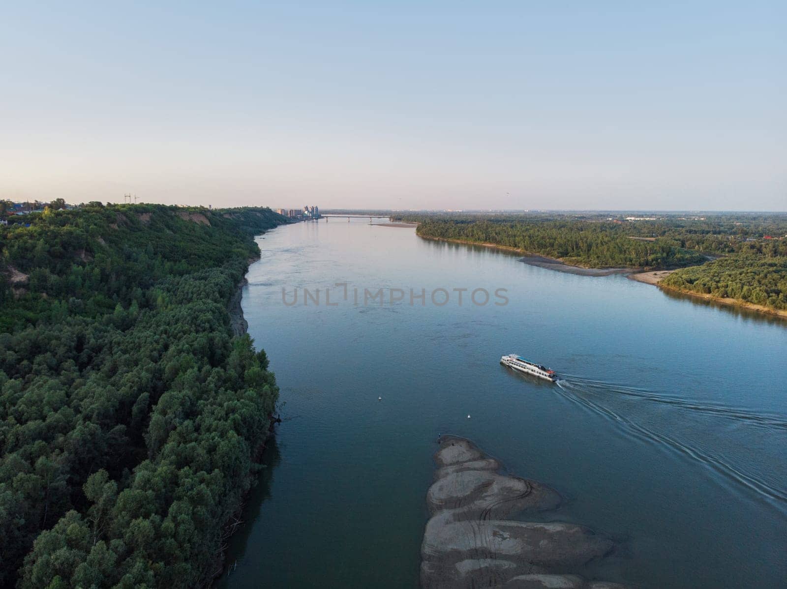 Aerial view of big siberian Ob river and ship, summer day, drone shot