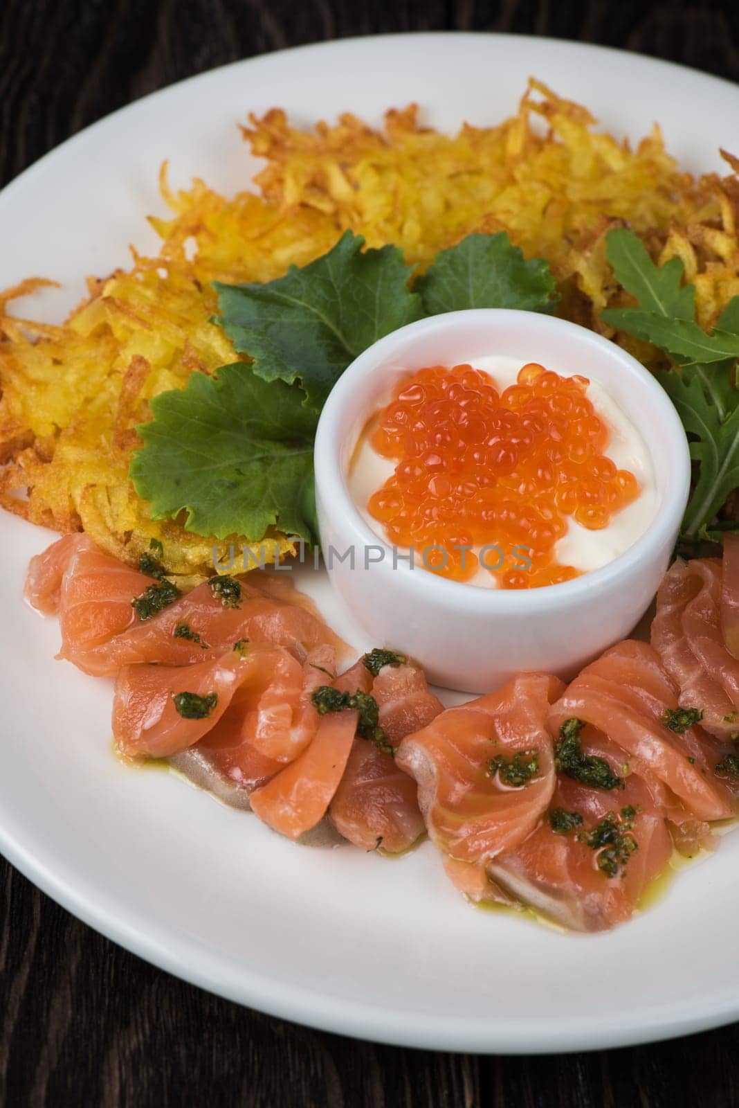 Plate with potato pancakes salmon fish and red caviar